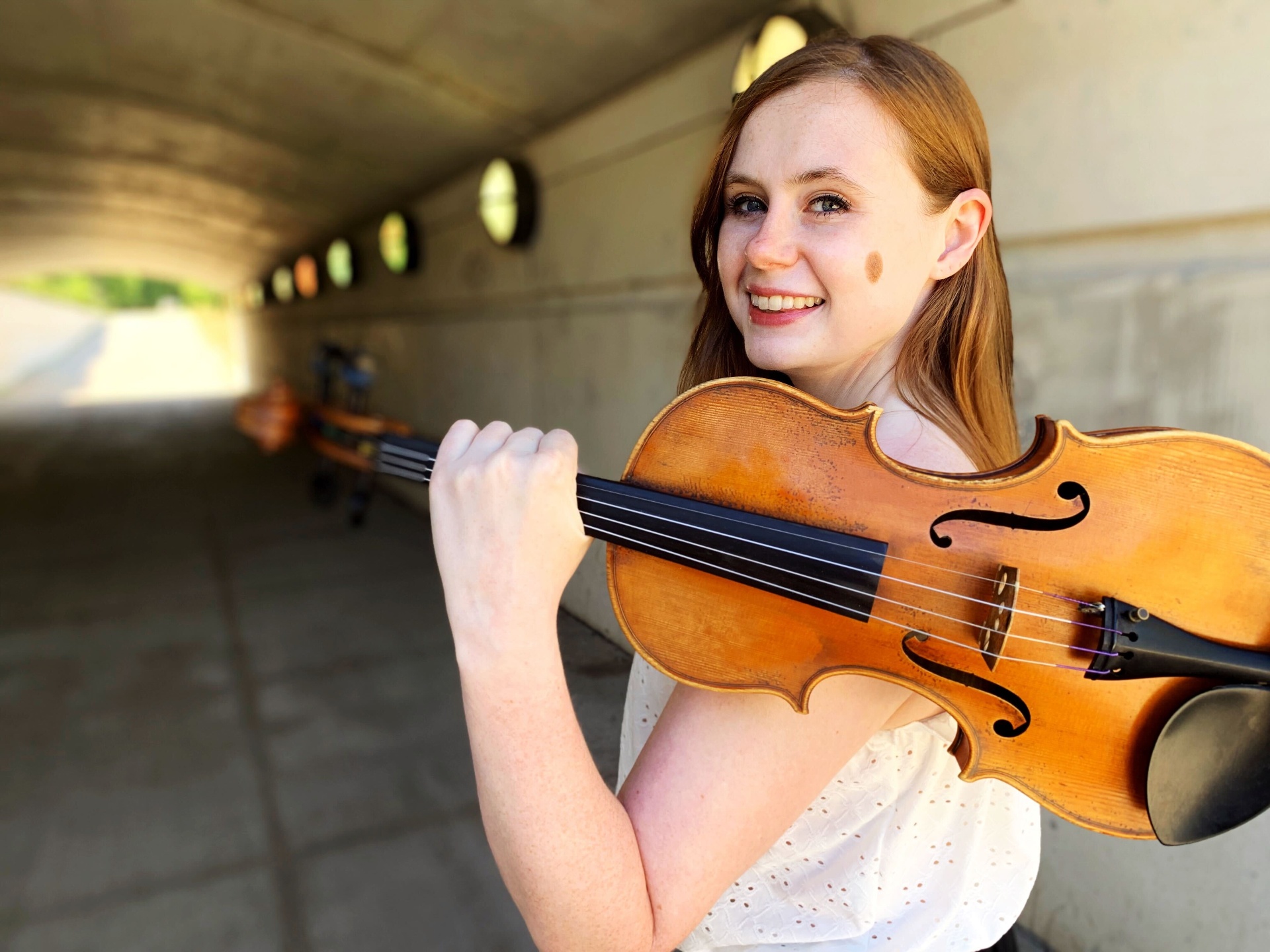 Meghan teaching violin online in a warm, inviting room